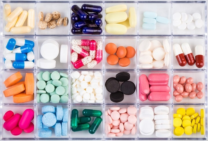 Various pills and capsules in container. Pharmaceuticals concept. SCAIR