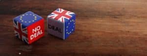 Brexit, deal or no deal concept. United Kingdom and European Union flags on dice, wooden background for SCAIR blog.