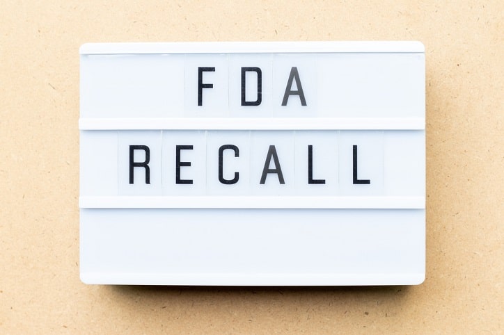 White lightbox with word fda recall on wood background