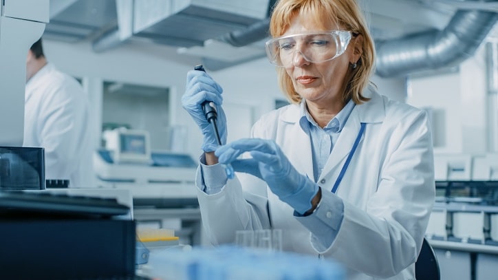 Female Research Scientist Uses Micro Pipein Innovative Pharmaceutical Laboratory with Modern Medical Equipment. 