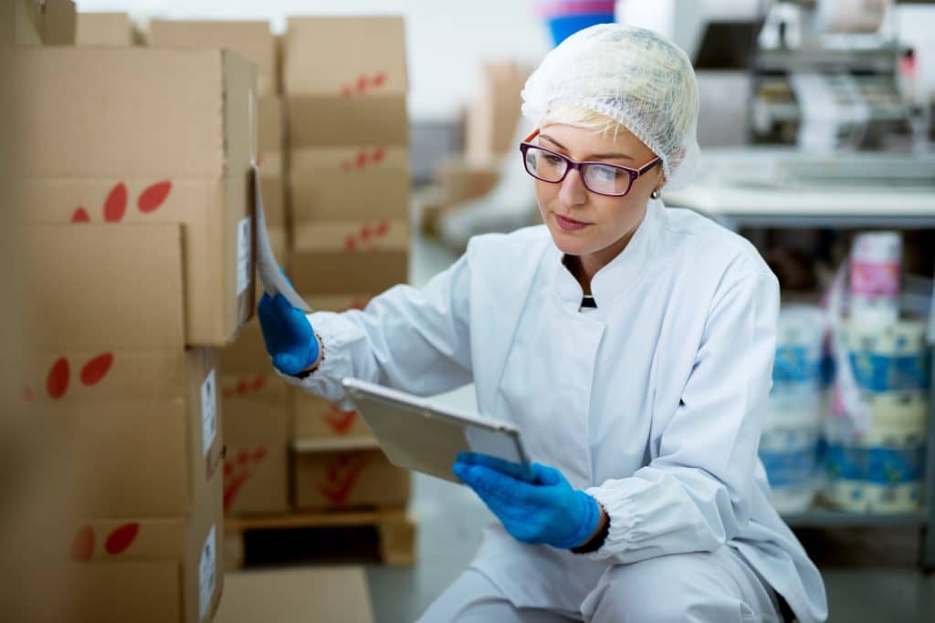 Factory worker checking inventory